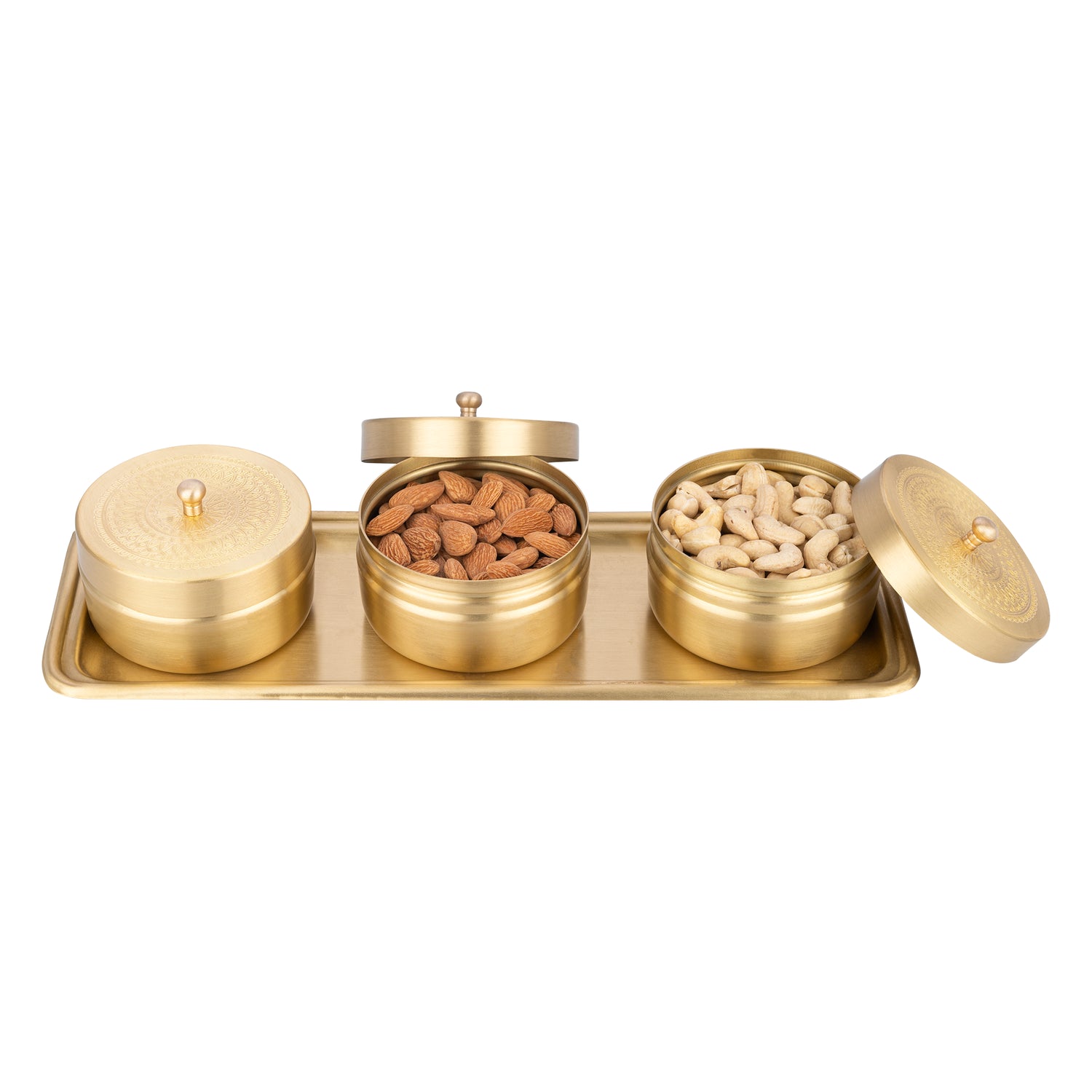 Set of three brass containers with lids on a white background