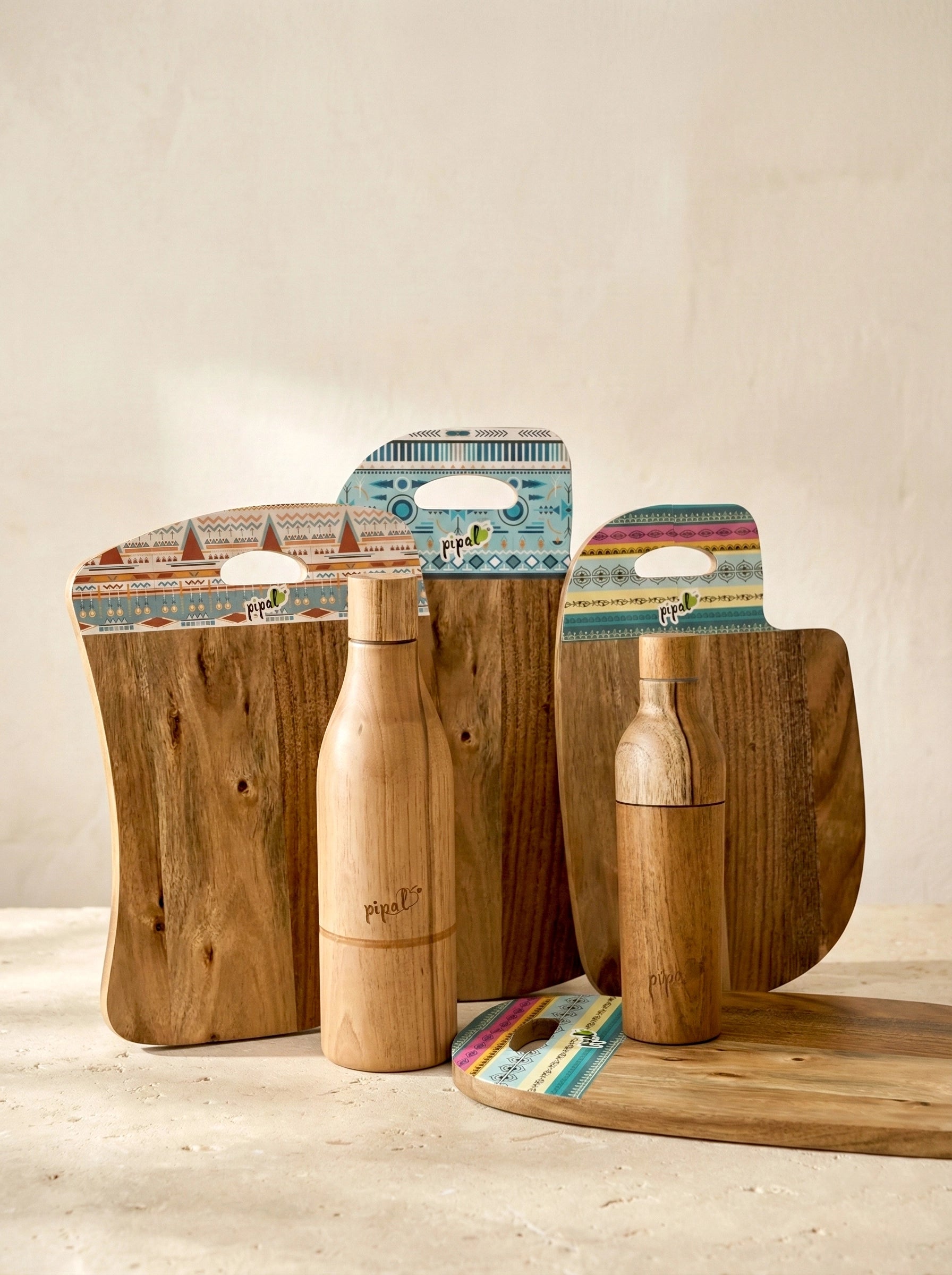 Wooden bottles with wooden chopping boards on a plaster surface